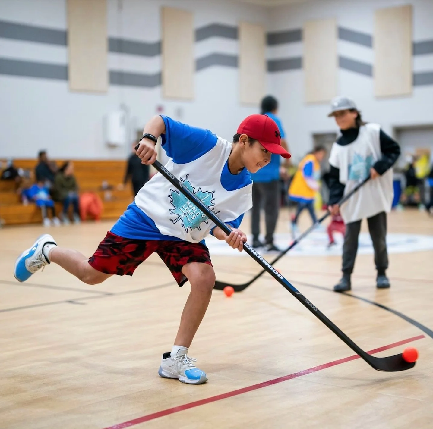 A young HWB player controls an orange ball during a development session